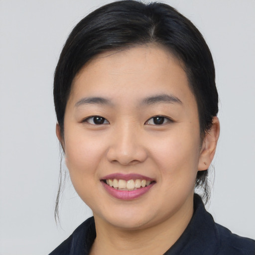 Joyful asian young-adult female with medium  black hair and brown eyes