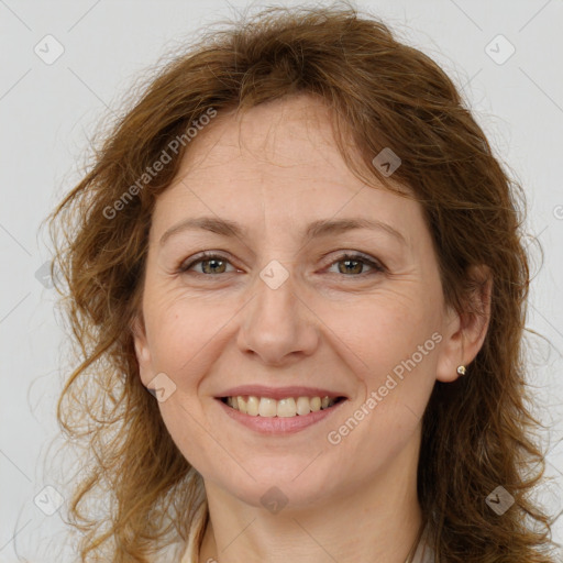 Joyful white adult female with long  brown hair and brown eyes