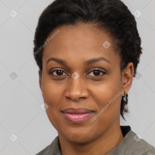 Joyful black adult female with short  black hair and brown eyes