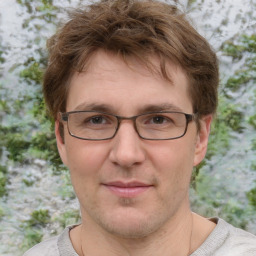 Joyful white adult male with short  brown hair and grey eyes