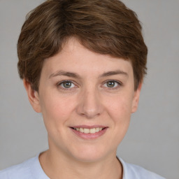 Joyful white young-adult female with short  brown hair and brown eyes