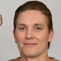 Joyful white young-adult male with short  brown hair and grey eyes