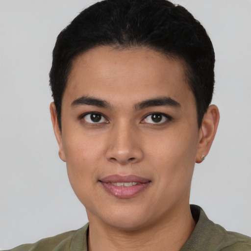 Joyful latino young-adult male with short  black hair and brown eyes