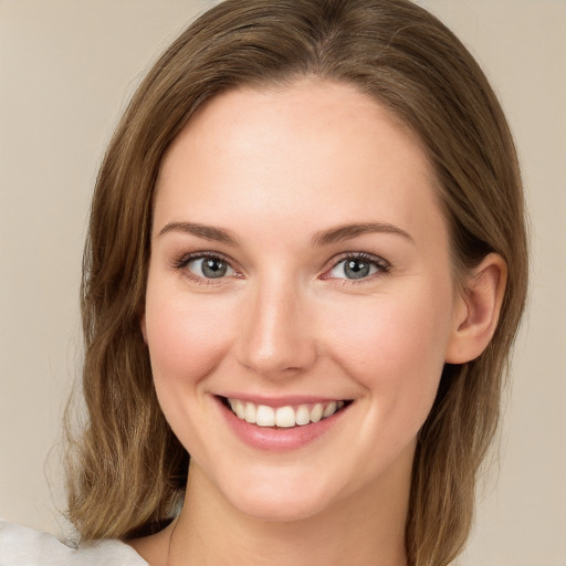 Joyful white young-adult female with medium  brown hair and green eyes