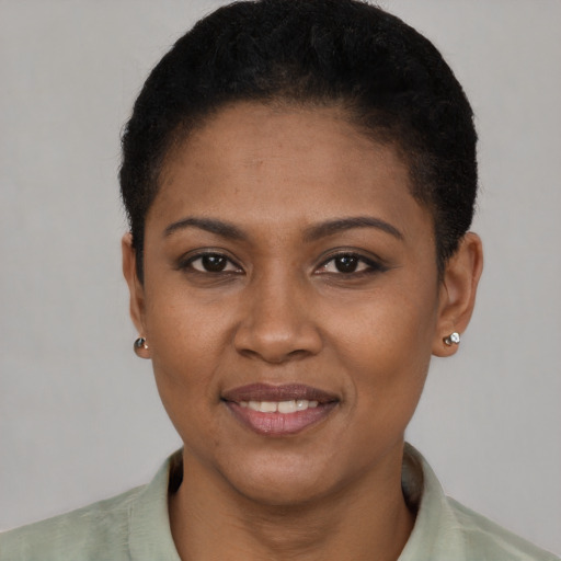 Joyful black young-adult female with short  black hair and brown eyes