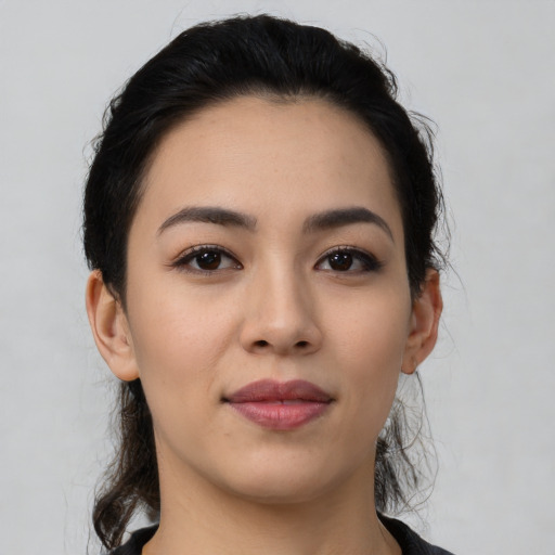 Joyful latino young-adult female with medium  black hair and brown eyes