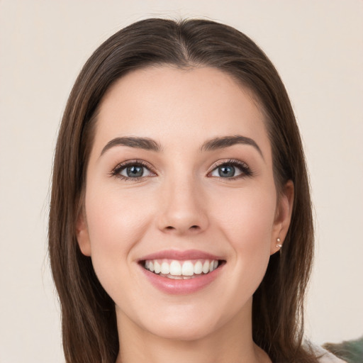 Joyful white young-adult female with long  brown hair and green eyes