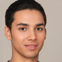 Joyful latino young-adult male with short  brown hair and brown eyes