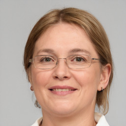 Joyful white adult female with medium  brown hair and grey eyes