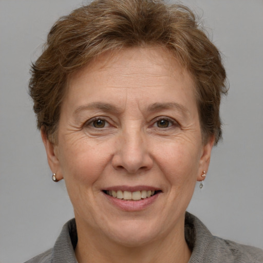 Joyful white middle-aged female with short  brown hair and grey eyes