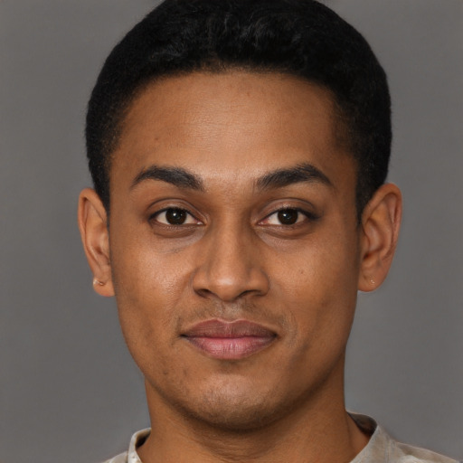 Joyful black young-adult male with short  black hair and brown eyes