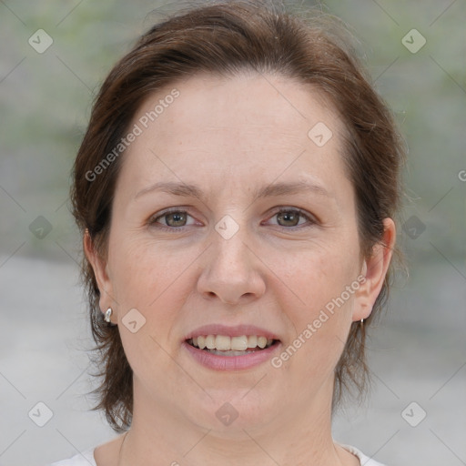 Joyful white adult female with medium  brown hair and brown eyes