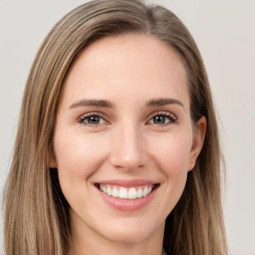 Joyful white young-adult female with long  brown hair and brown eyes