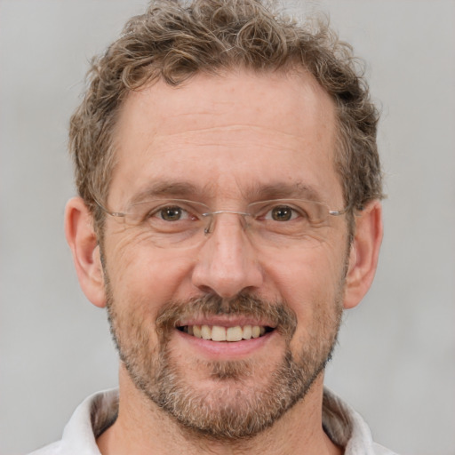 Joyful white adult male with short  brown hair and grey eyes