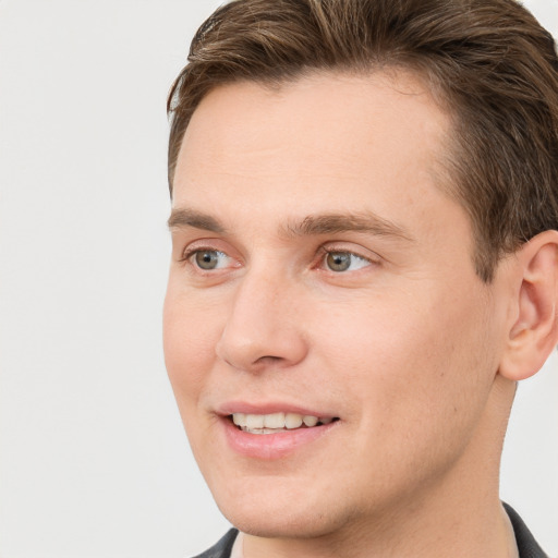 Joyful white young-adult male with short  brown hair and grey eyes