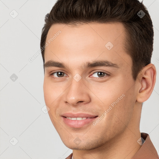 Joyful white young-adult male with short  brown hair and brown eyes