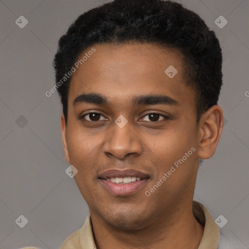 Joyful black young-adult male with short  brown hair and brown eyes