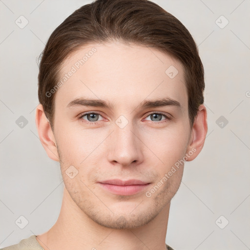 Joyful white young-adult male with short  brown hair and grey eyes