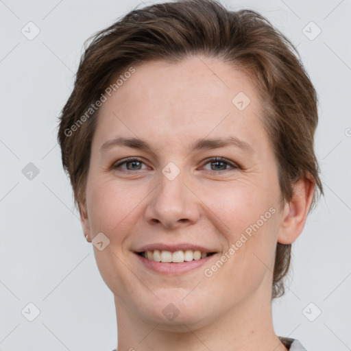 Joyful white young-adult female with short  brown hair and grey eyes