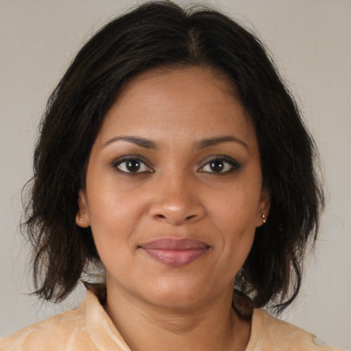 Joyful black young-adult female with medium  brown hair and brown eyes