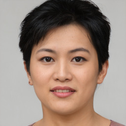 Joyful asian young-adult female with short  brown hair and brown eyes