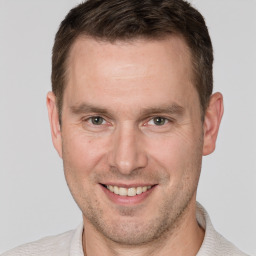 Joyful white adult male with short  brown hair and brown eyes