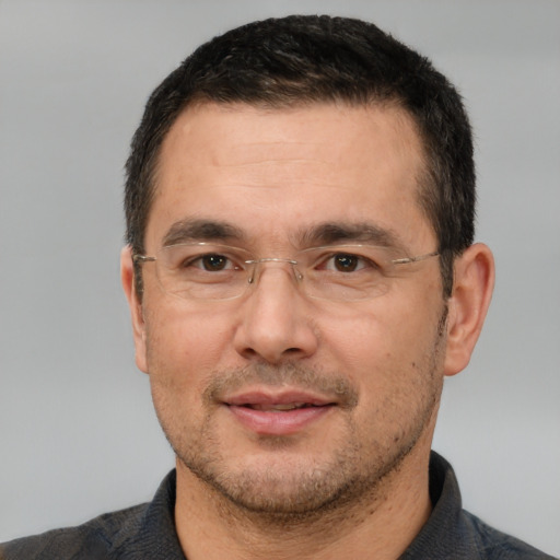 Joyful white adult male with short  brown hair and brown eyes