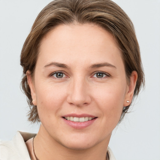 Joyful white adult female with medium  brown hair and grey eyes