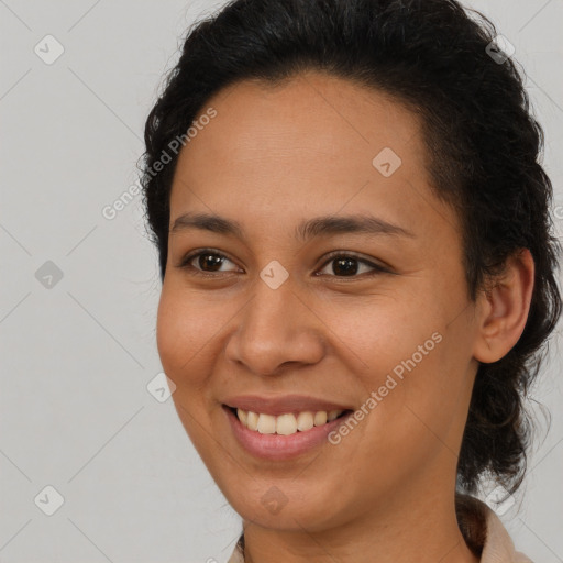 Joyful latino young-adult female with medium  brown hair and brown eyes