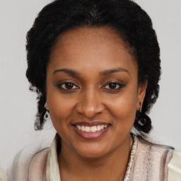 Joyful black young-adult female with short  black hair and brown eyes