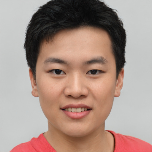 Joyful asian young-adult male with short  brown hair and brown eyes
