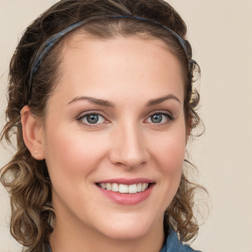 Joyful white young-adult female with long  brown hair and blue eyes