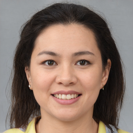 Joyful white young-adult female with medium  brown hair and brown eyes