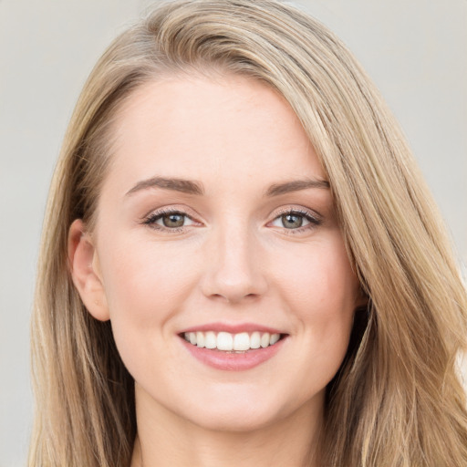 Joyful white young-adult female with long  brown hair and blue eyes