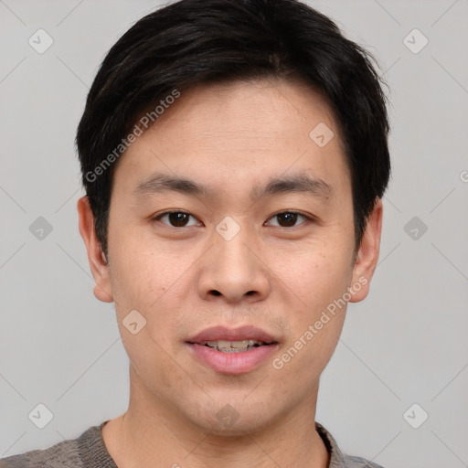 Joyful asian young-adult male with short  black hair and brown eyes