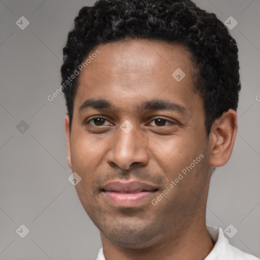 Joyful black young-adult male with short  black hair and brown eyes