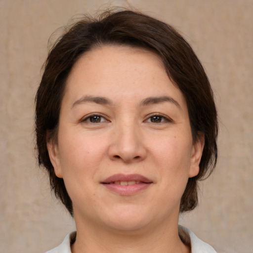 Joyful white young-adult female with medium  brown hair and brown eyes