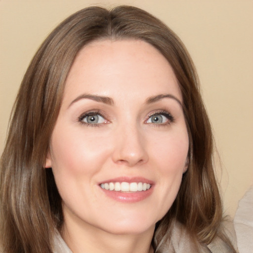 Joyful white young-adult female with long  brown hair and brown eyes