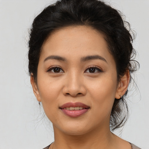 Joyful asian young-adult female with medium  black hair and brown eyes