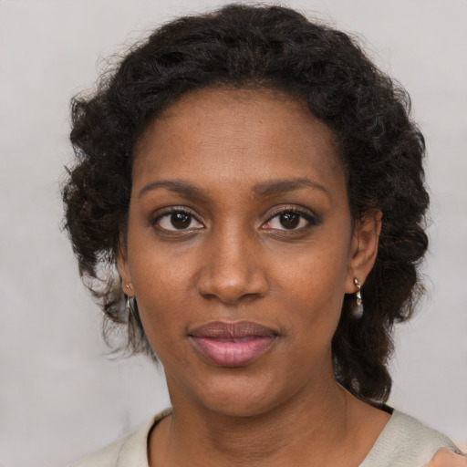 Joyful black young-adult female with medium  brown hair and brown eyes