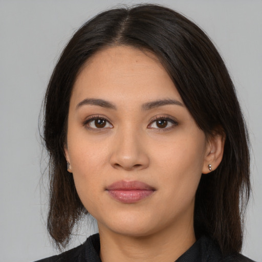 Joyful white young-adult female with long  brown hair and brown eyes