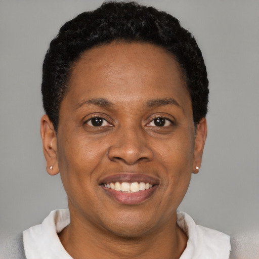 Joyful black young-adult female with short  black hair and brown eyes