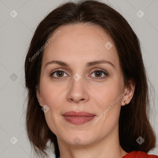 Joyful white adult female with long  brown hair and brown eyes