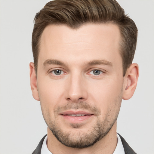 Joyful white young-adult male with short  brown hair and grey eyes