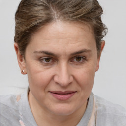 Joyful white adult female with short  brown hair and grey eyes