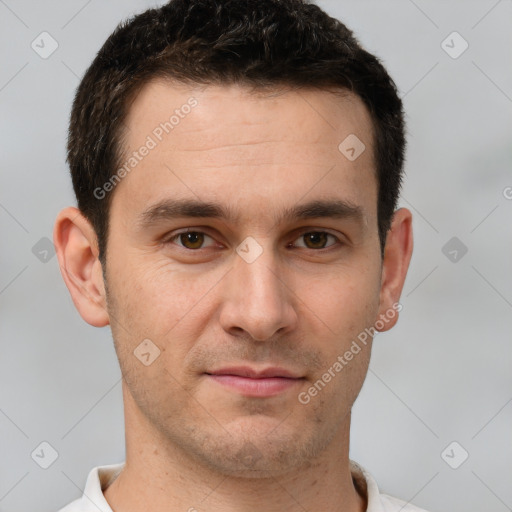 Joyful white young-adult male with short  brown hair and brown eyes