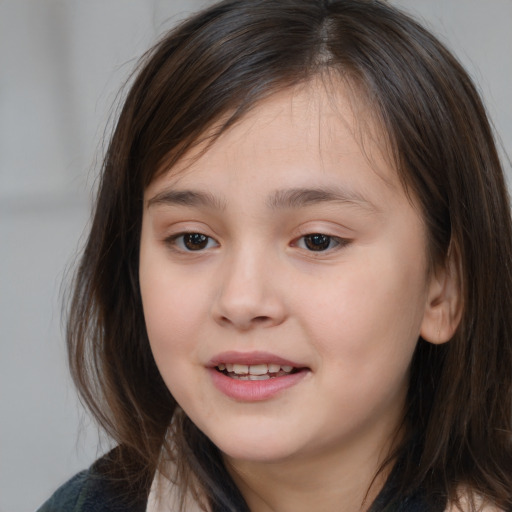 Joyful white child female with medium  brown hair and brown eyes