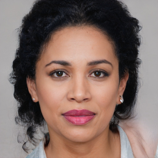 Joyful latino young-adult female with medium  black hair and brown eyes