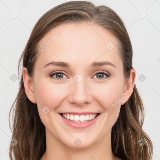 Joyful white young-adult female with long  brown hair and blue eyes