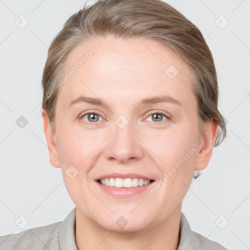 Joyful white young-adult female with short  brown hair and grey eyes